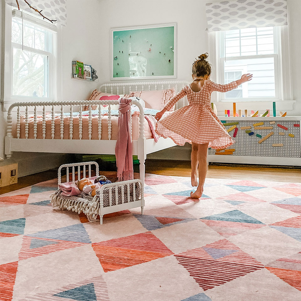 Orange and pink rug with diamonds in girls bedroom