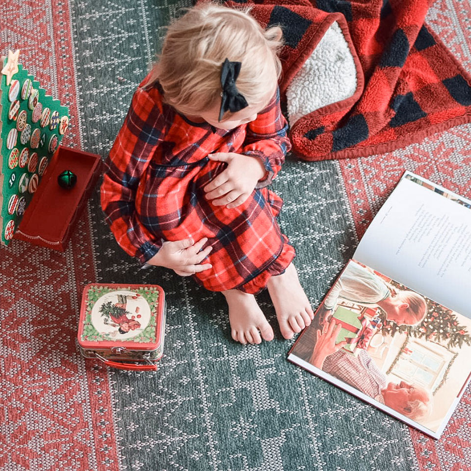 Kid reading on a holiday rug