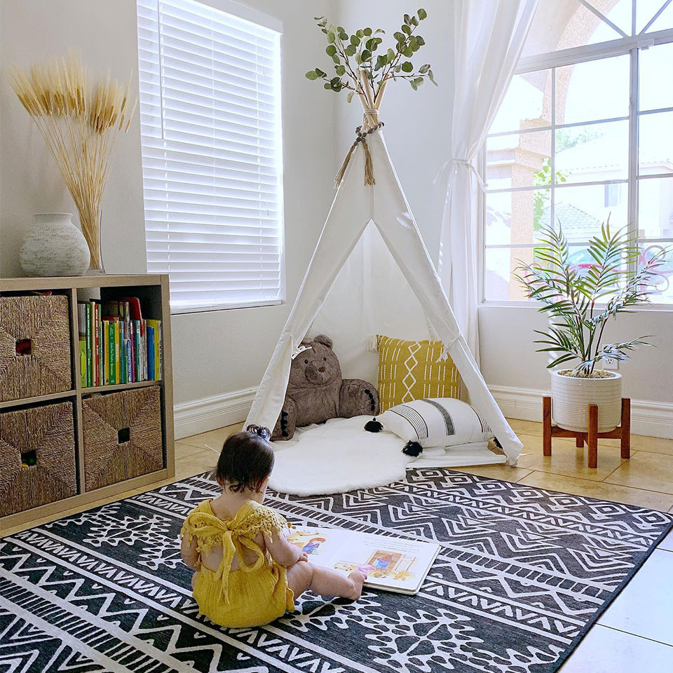 Toddler Reading Book with teepee on Linear Aztec Black Rug in Kids Room