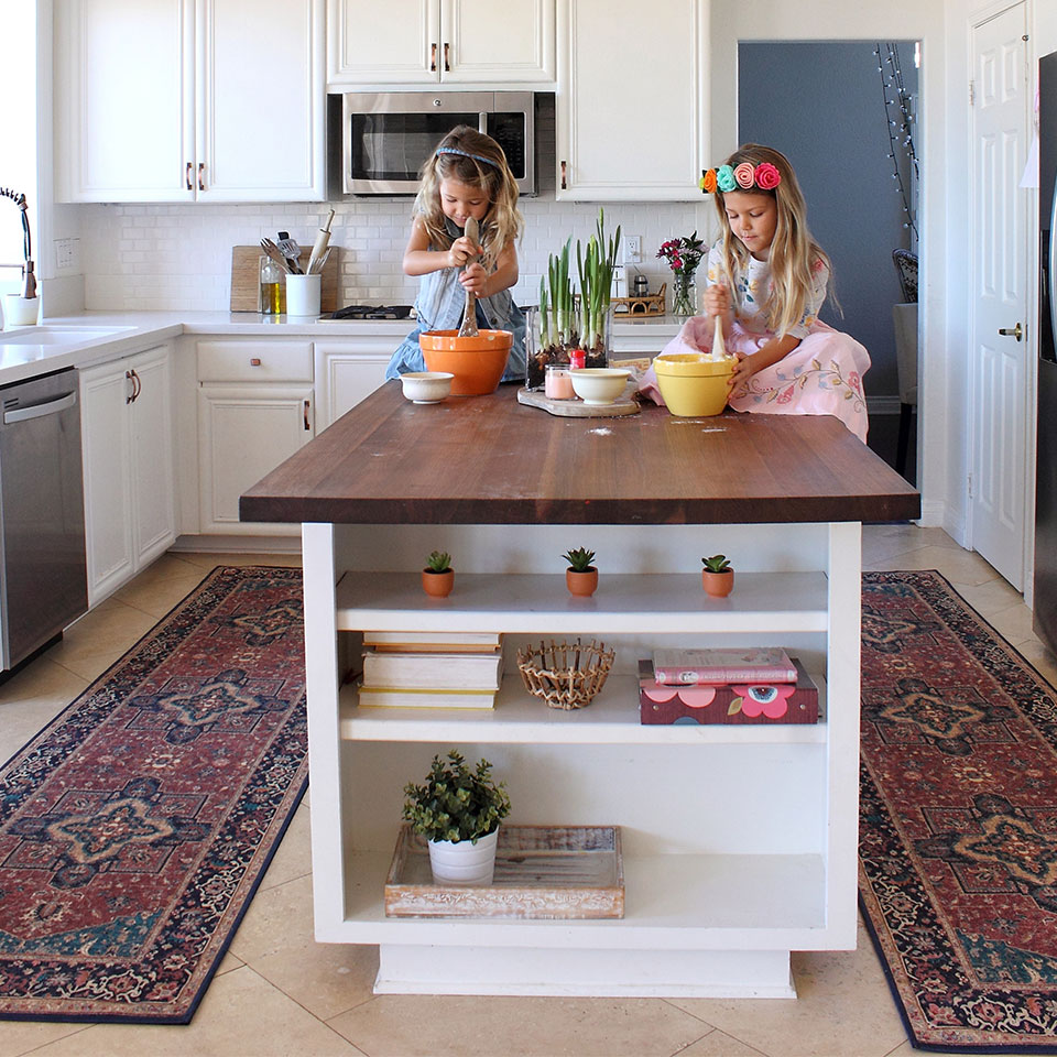 Burgundy persian runner rugs in the kitchen with 2 kids baking