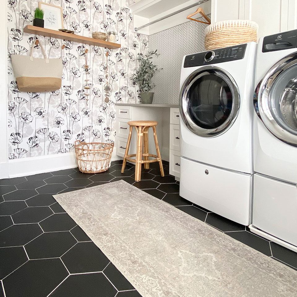 Cream persian runner rug in the laundry room with floral wallpaper and rattan baskets