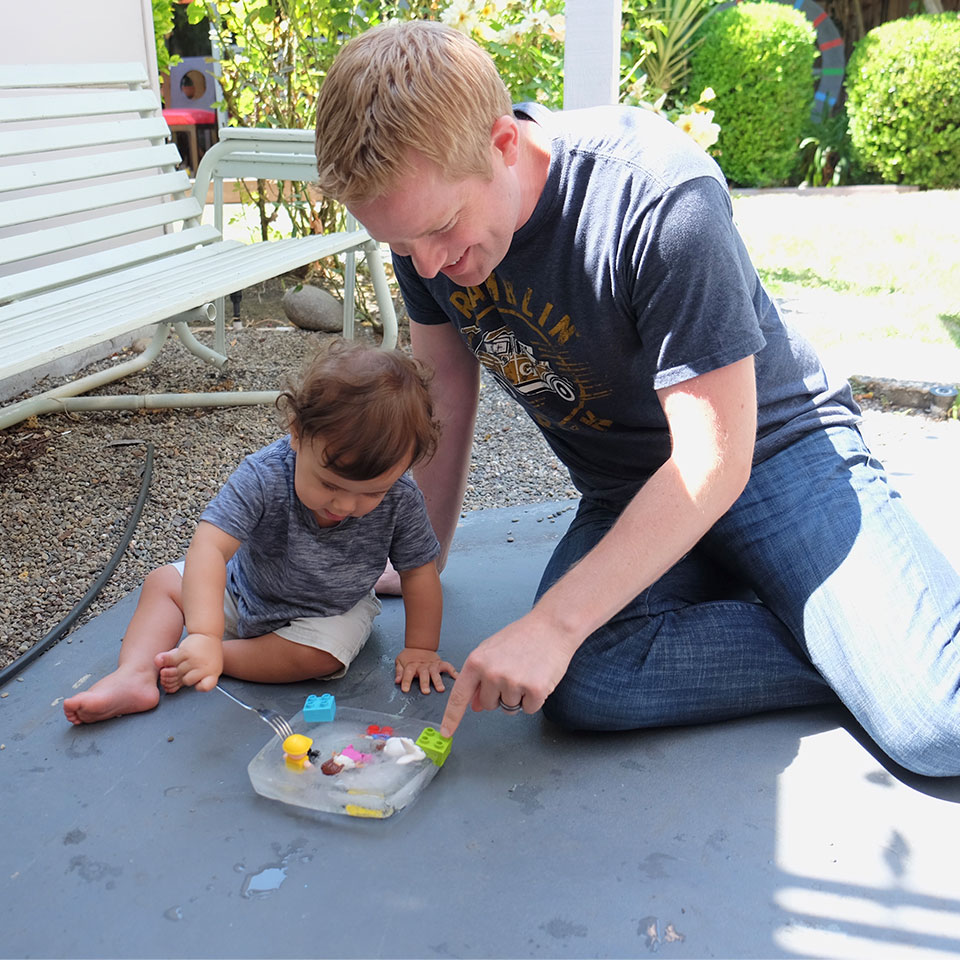 Toddler and dad playing outside