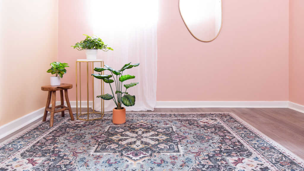 Pink wall with plants and Persian rug
