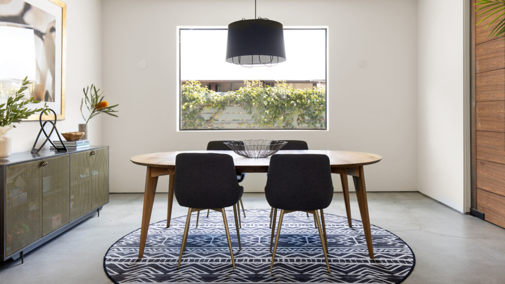 Round black and white rug under dining table