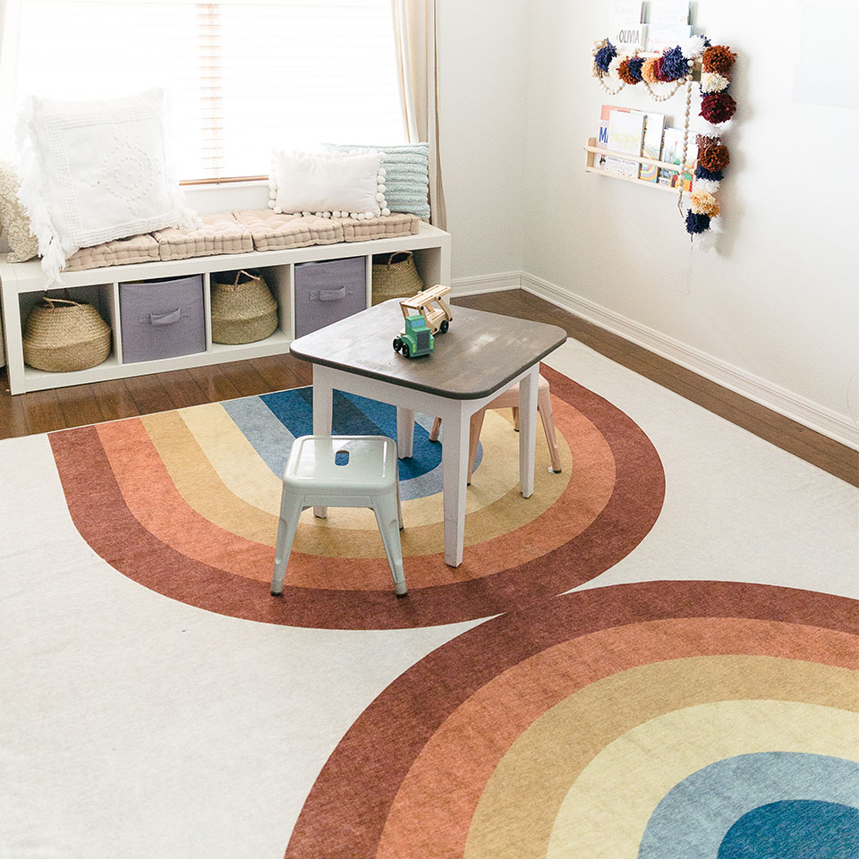 Rainbow rug in kids playroom and homeschool.