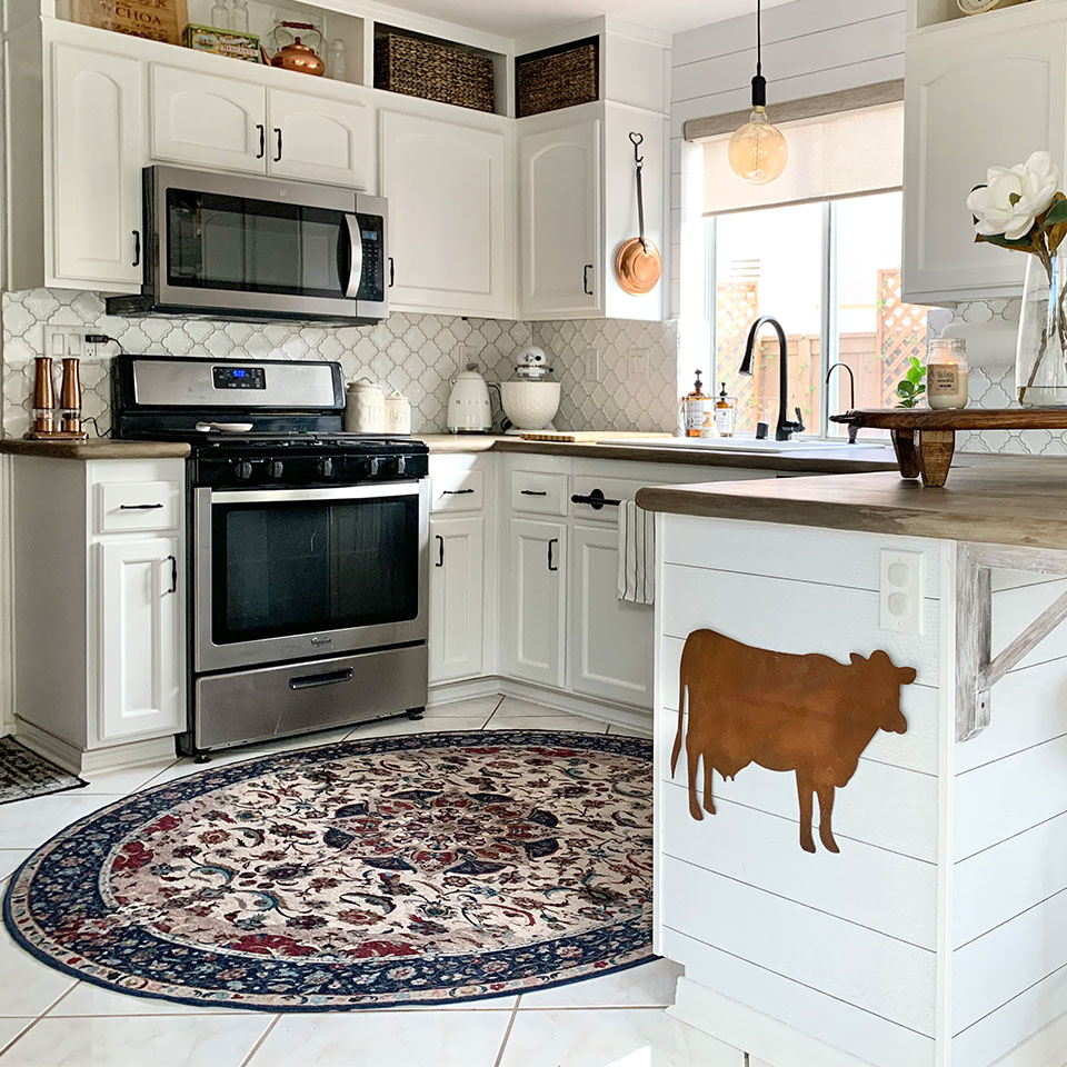 red and blue floral round rug in all white kitchen