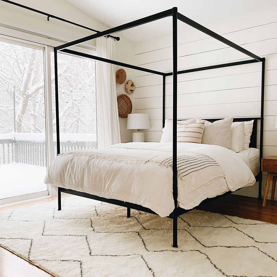 cozy bedroom with canopy bed and white decor
