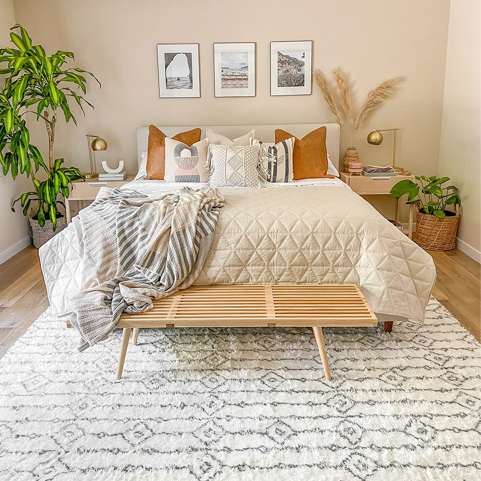 white plush rug in bedroom with wooden bench and plants