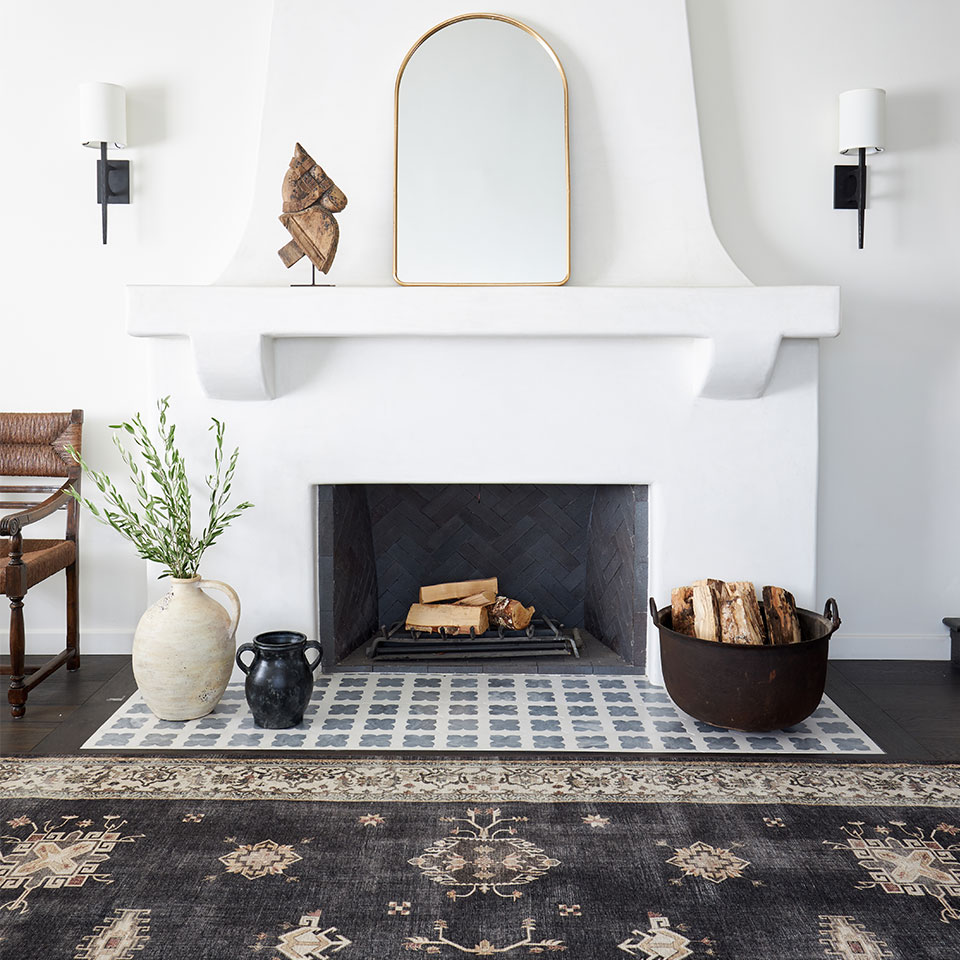 Bordered farmhouse rug by the fireplace