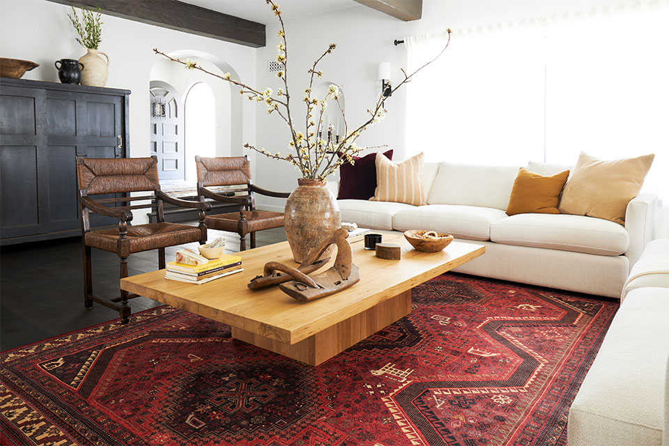 Red farmhouse rug with white couch in living room
