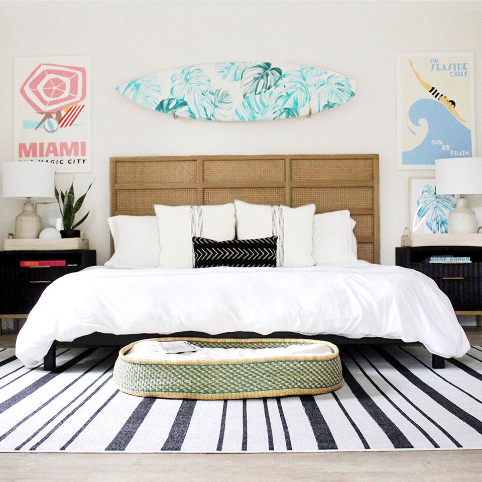 Black and white stripes rug in bedroom with surf board