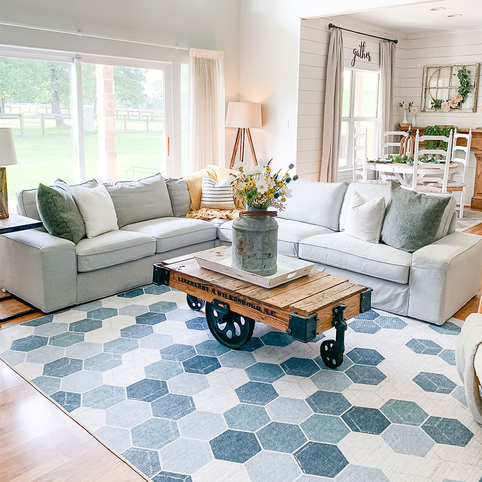 Blue geometric rug with grey couch in farmhouse living room