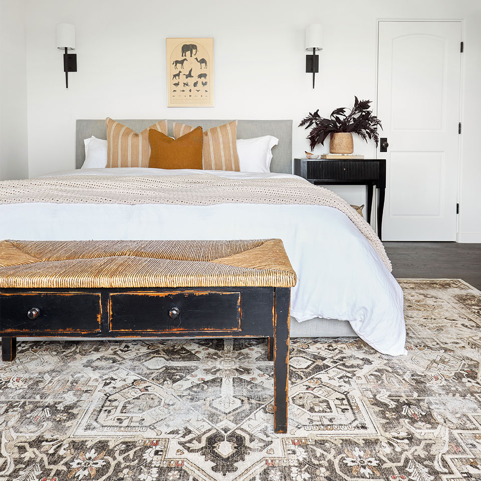 Brown farmhouse rug with queen bed in bedroom