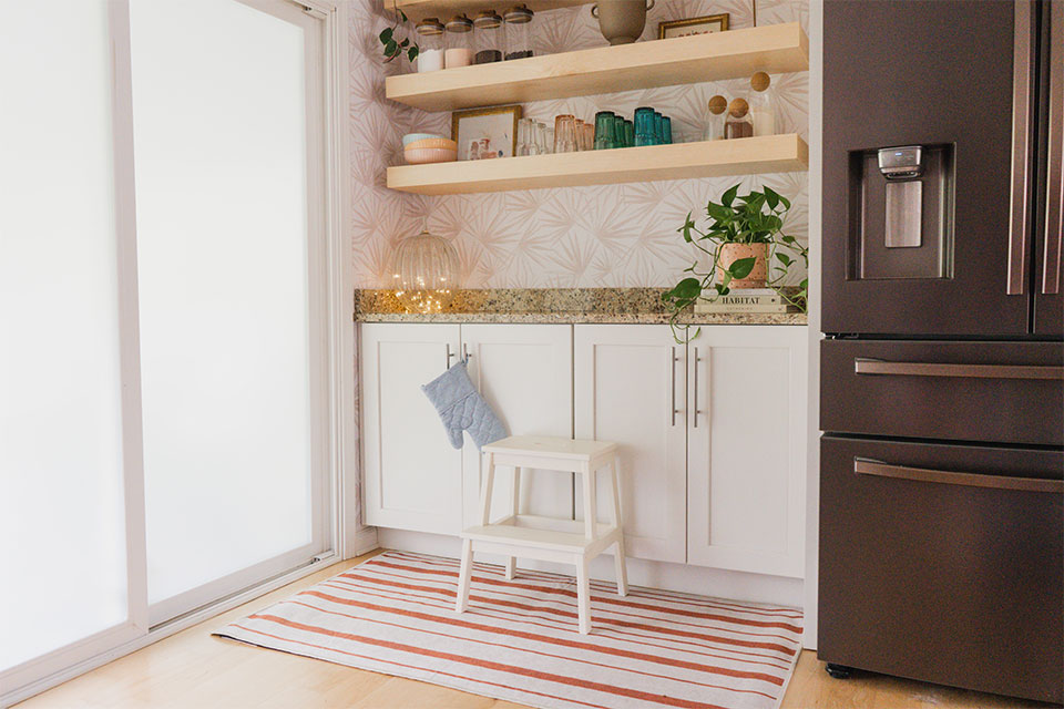 Fall kitchen decor with orange striped rug and shelf.