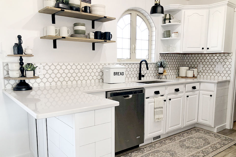 Modern farmhouse kitchen with white cabinets hexagon tile and grey persian rug