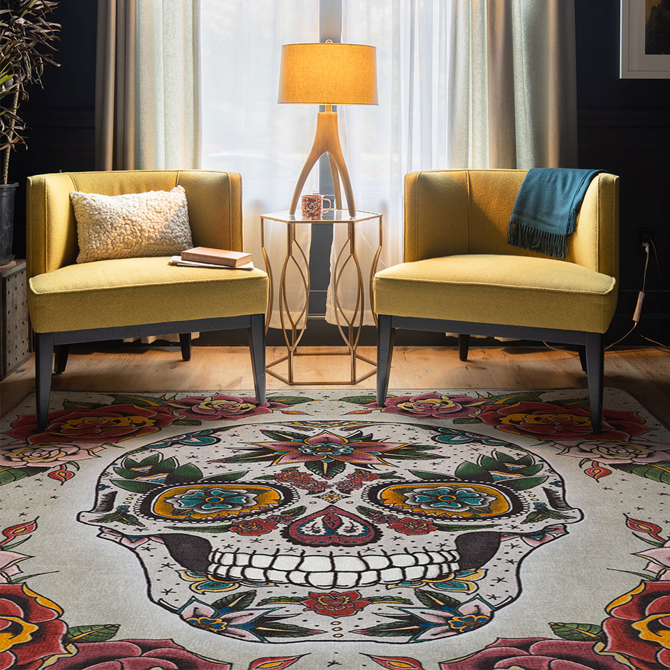 Sugar skull rug with yellow accent chairs and lamp in the living room.