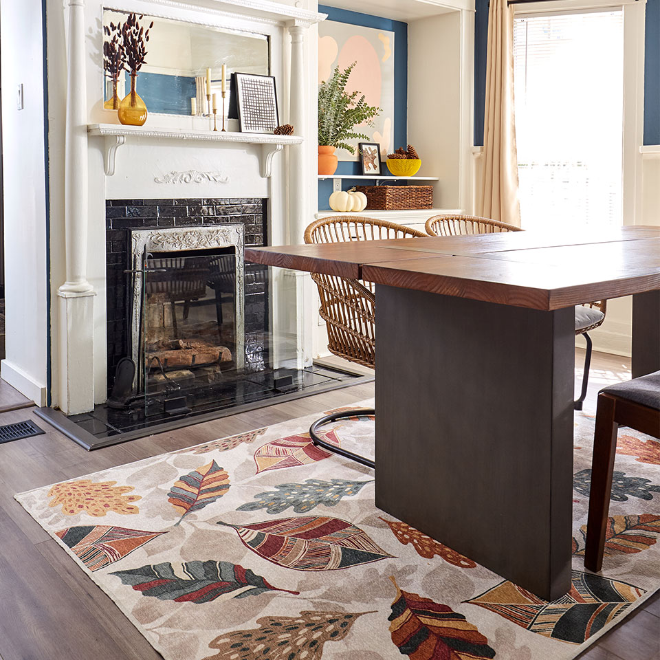 fall leaves rug by fireplace in dining room
