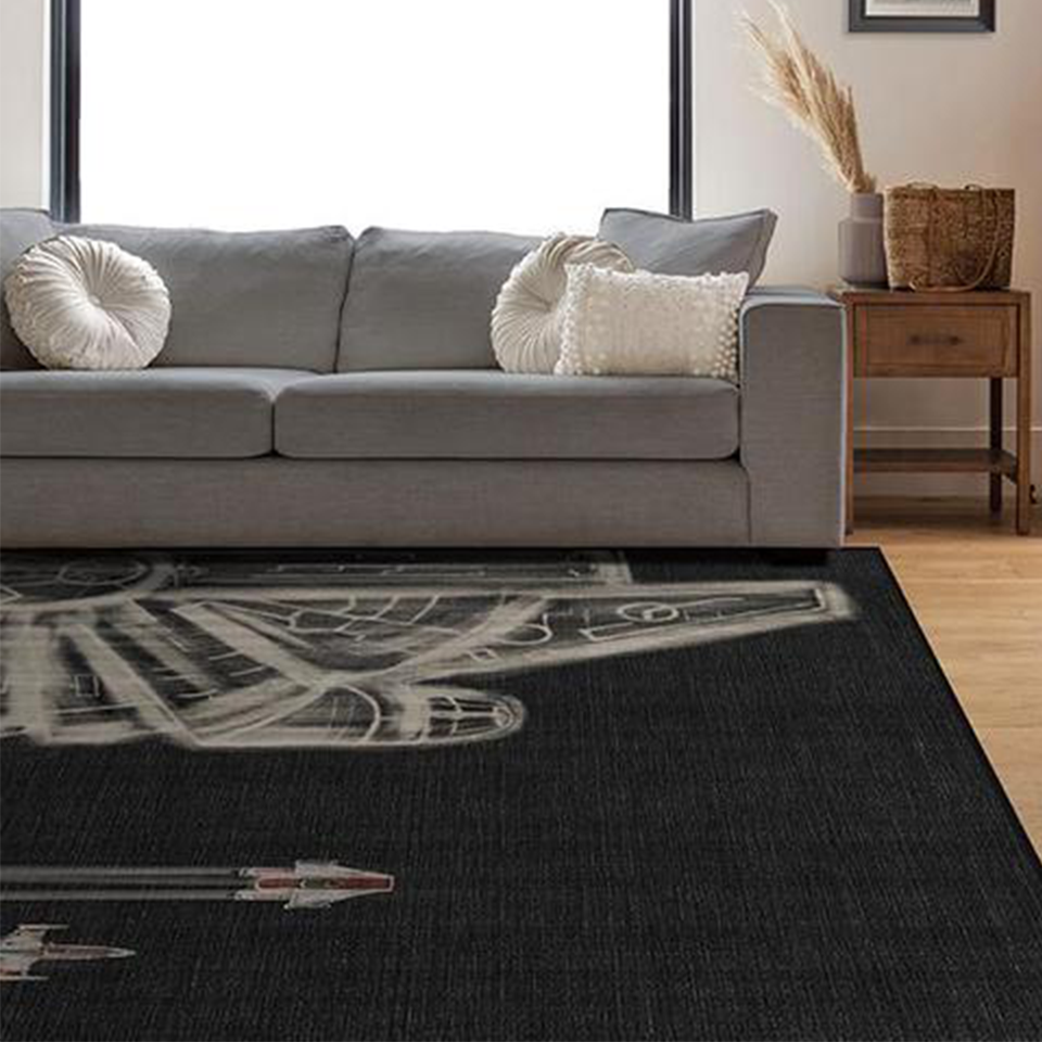black and white star wars rug in living room with grey sofa