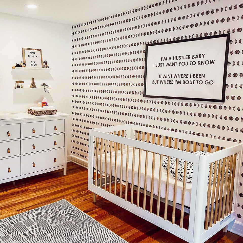 black and white nursery rug with black and white wallpaper and decor