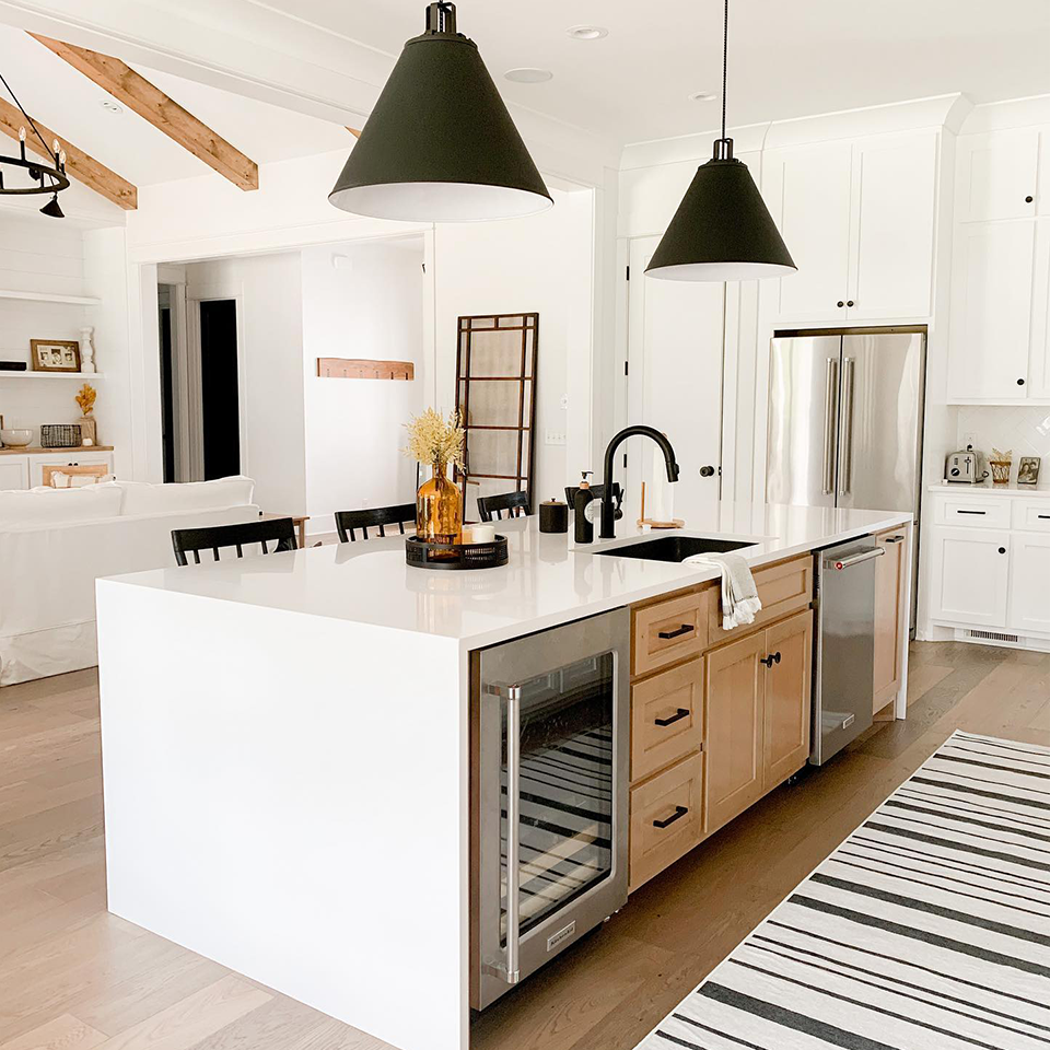 black and white striped runner rug in kitchen with white counters island and pendant lights