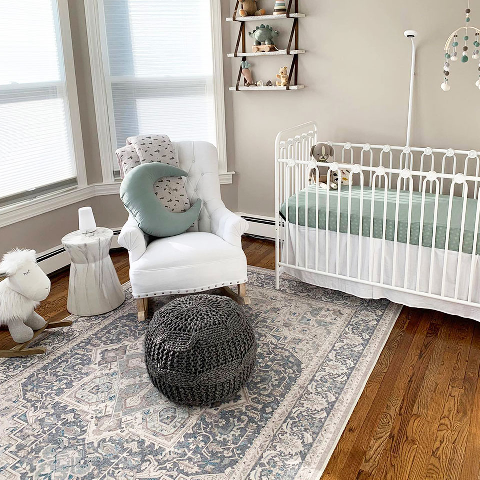 blue and neutral persian rug in nursery