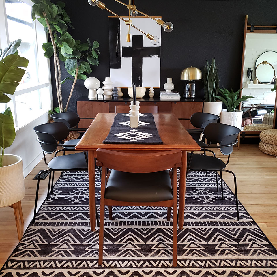 black and white rug in dining room with black wall