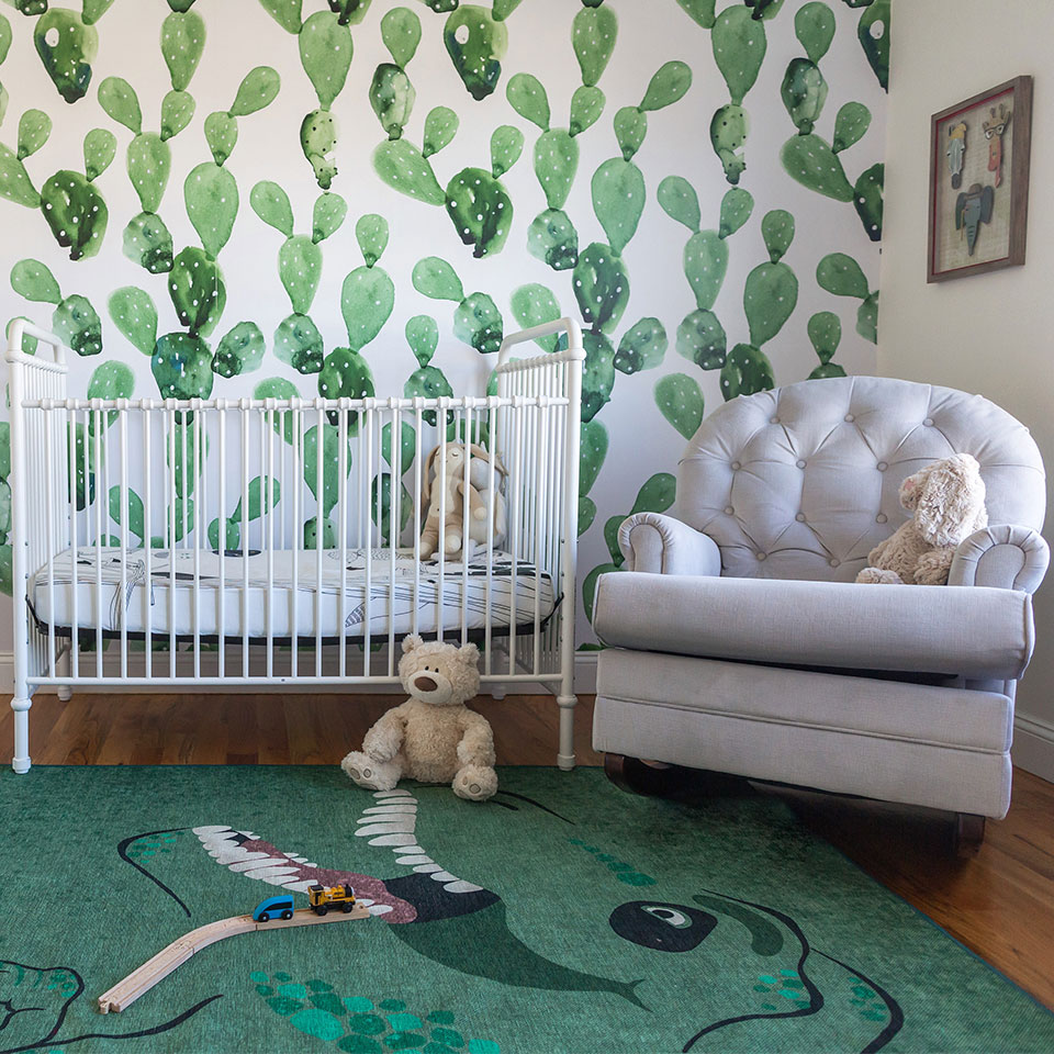 green kids rug in nursery with wallpaper wall