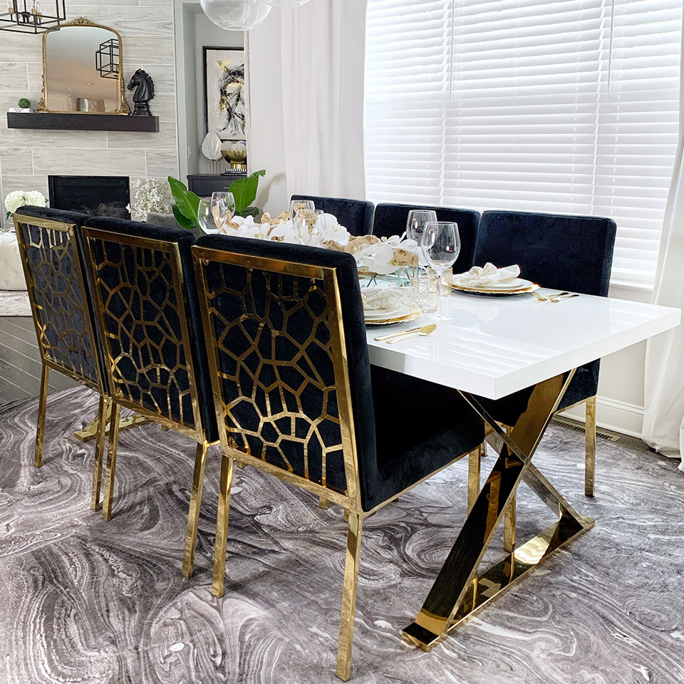 grey marble rug in dining room with black and gold chairs