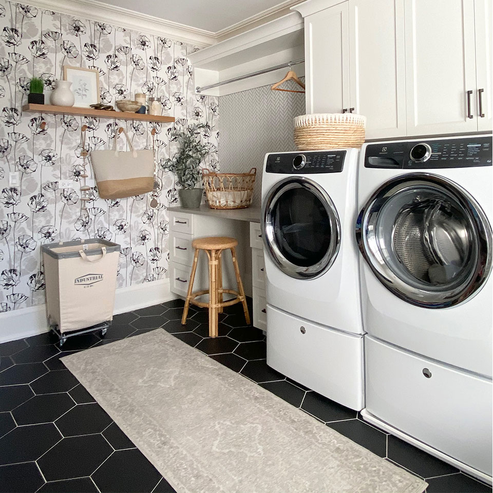 laundry room with cream persian rug black tile floor and wallpaper