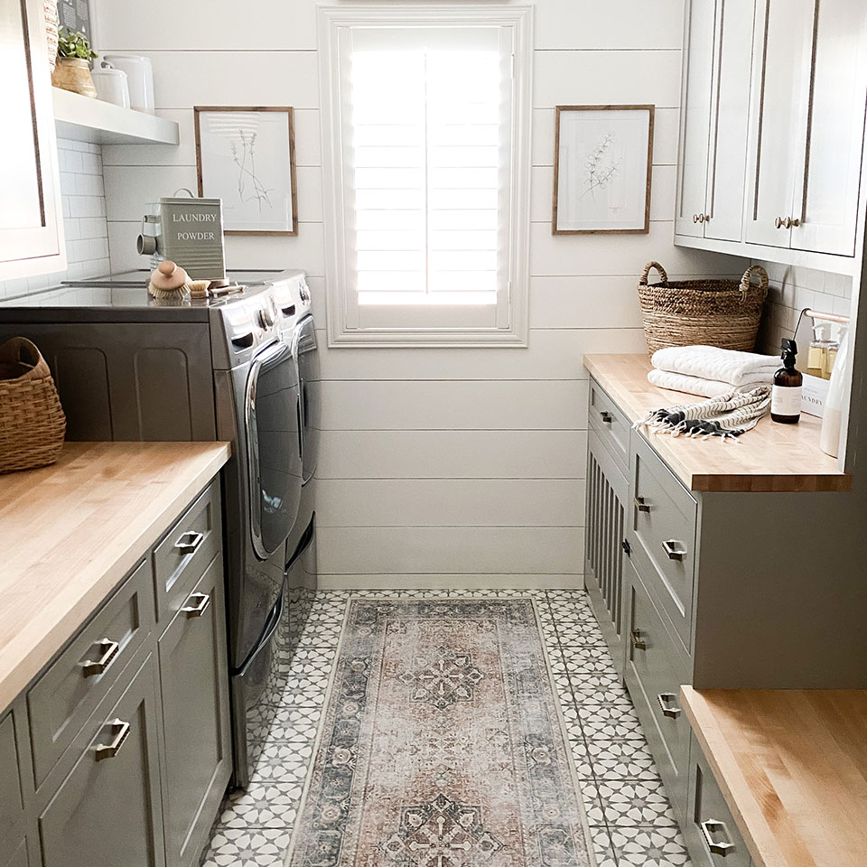 laundry room with farmhouse runner rug and green cabinets