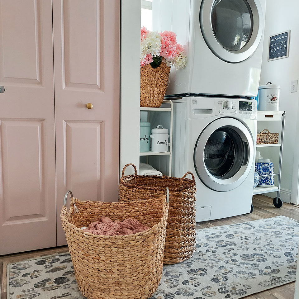 laundry room with pink door and leopard rug