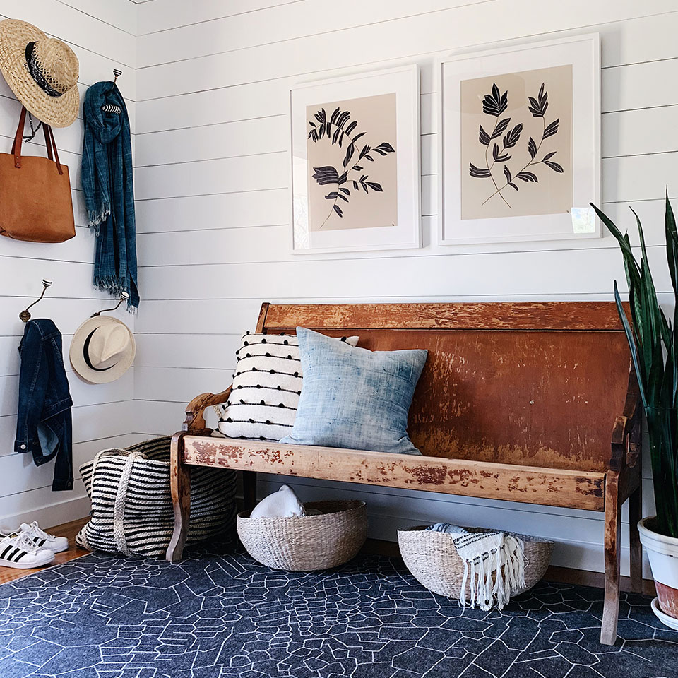 spring blue geometric rug in entryway with rustic bench and farmhouse decor