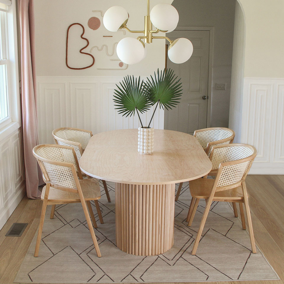 brown and tan dining room rug under unique dining table with modern decor