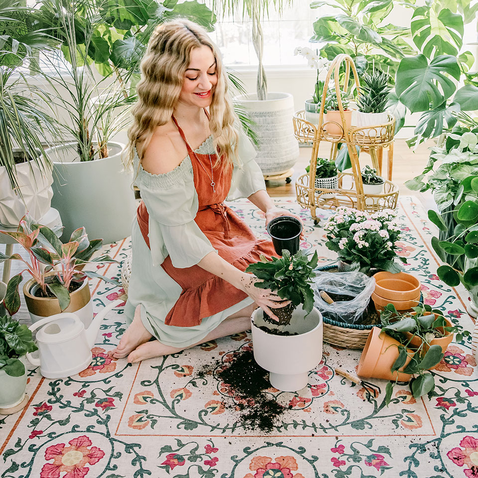 floral spring rug with woman sitting on floor tending to plants