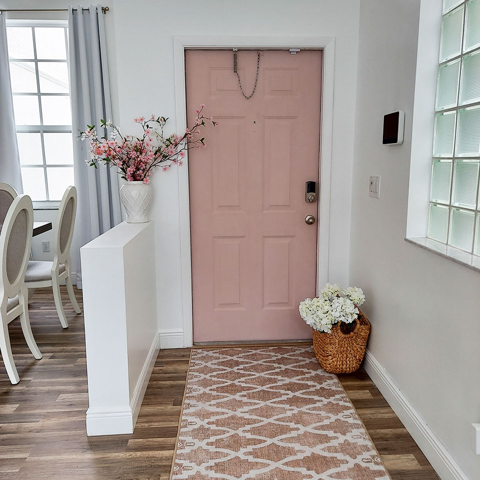 rose gold runner rug in small entryway foyer with pink door
