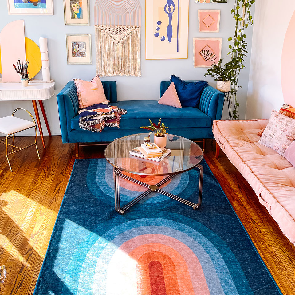 Blue couch with blue rug in eclectic living room