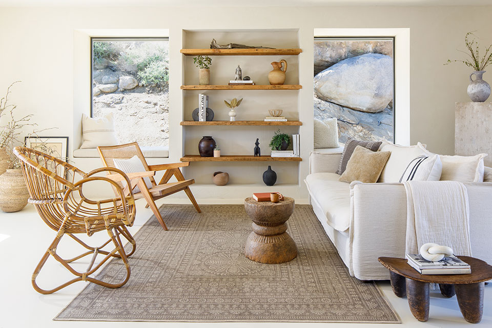 Brown re-jute rug in desert style living room with cream couch and wooden furniture and shelves