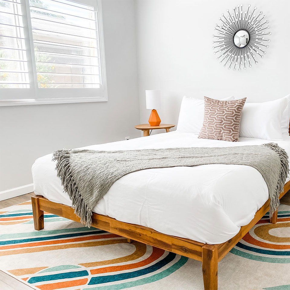 bedroom with rainbow midcentury modern rug