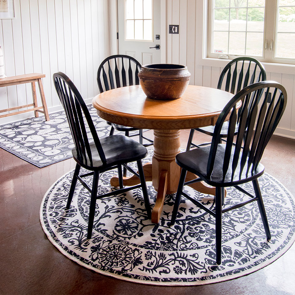 black and white floral rugs in farmhouse dining room