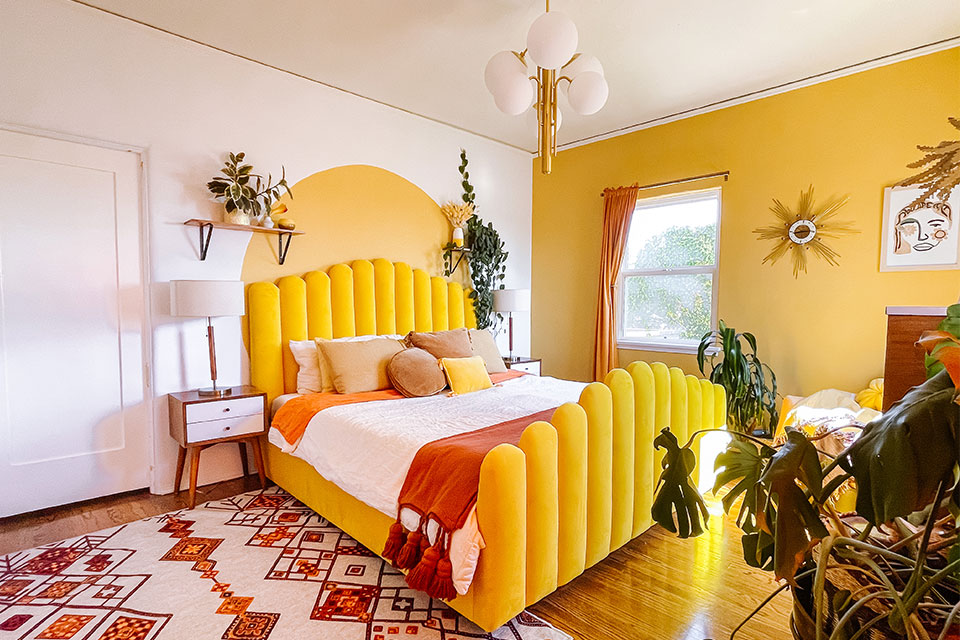 bright yellow and orange bedroom with bold rug