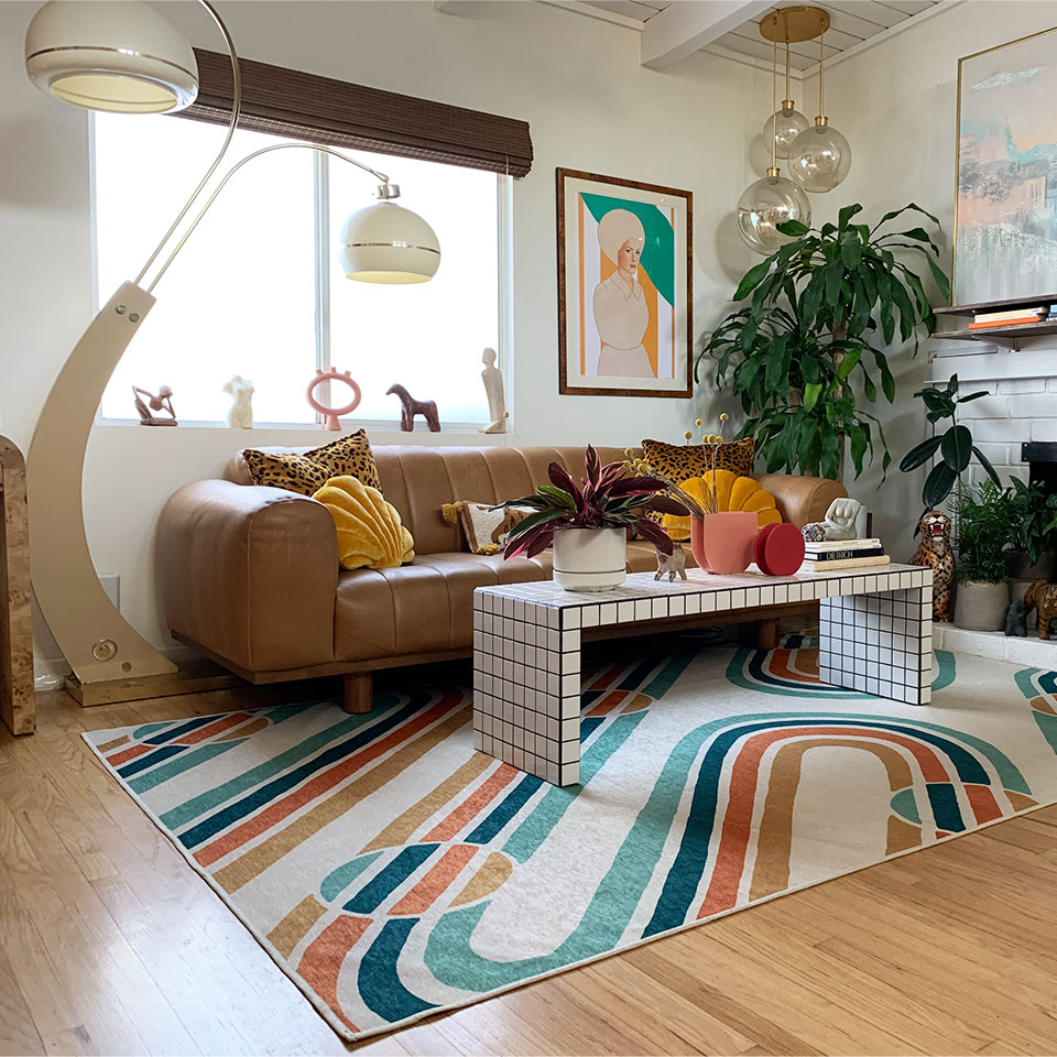 brown couch with mid century modern rug in living room
