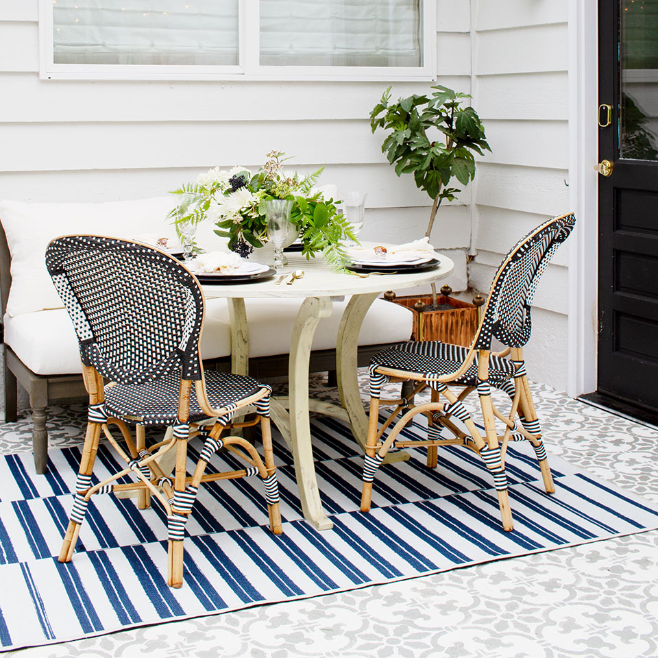 outdoor blue striped rug on patio under dining table