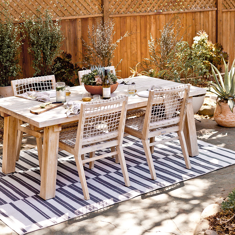 outdoor striped rug under dining table on patio