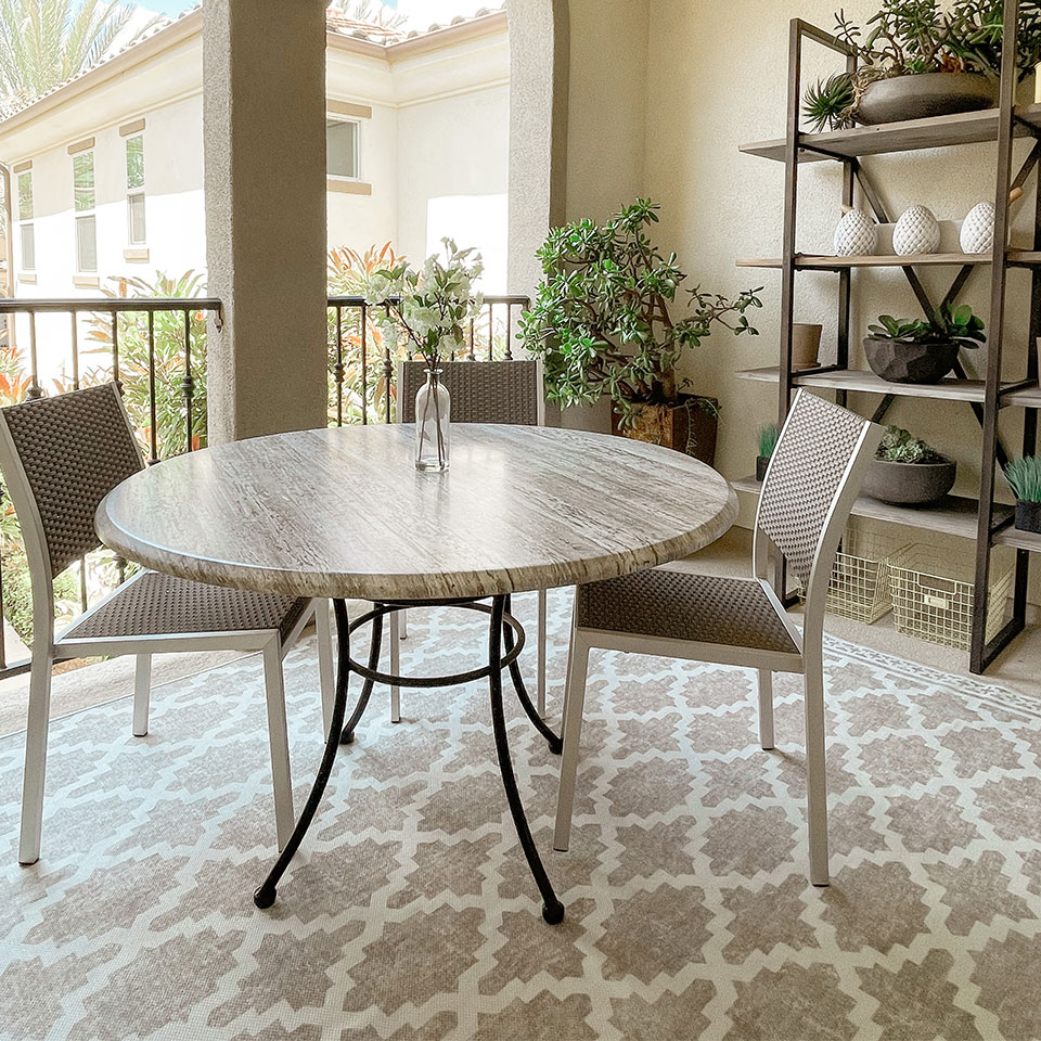 small outdoor tan trellis rug with table and chairs