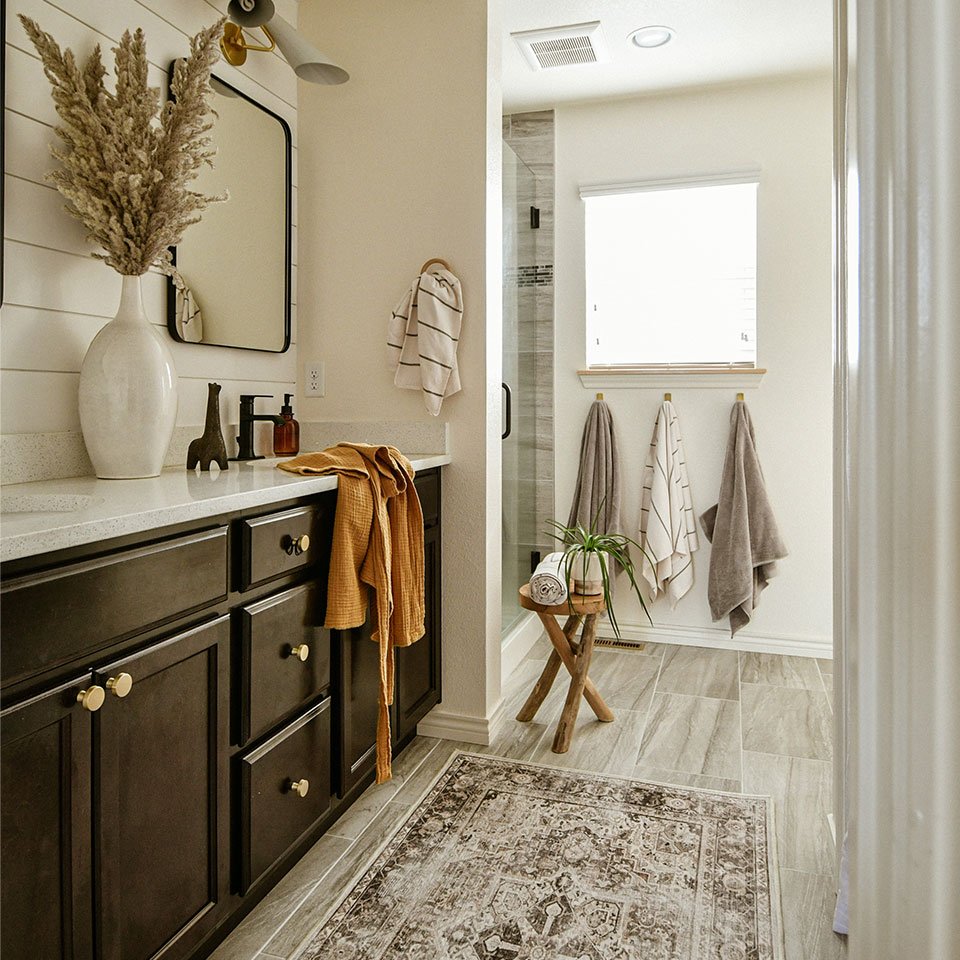 brown persian rug in neutral bathroom