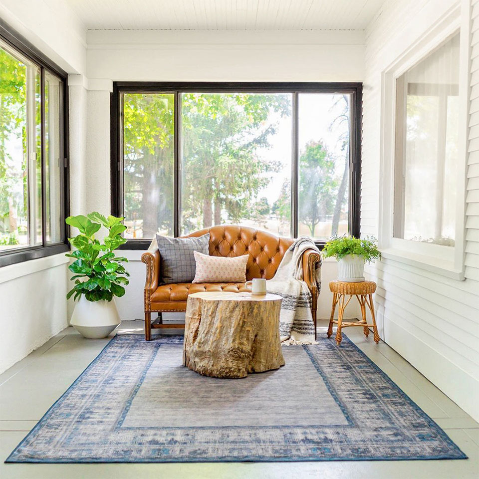 calming blue rug on porch with brown sofa
