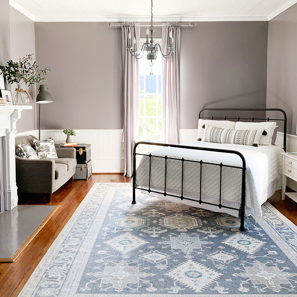 calming grey persian rug in bedroom with purple wall