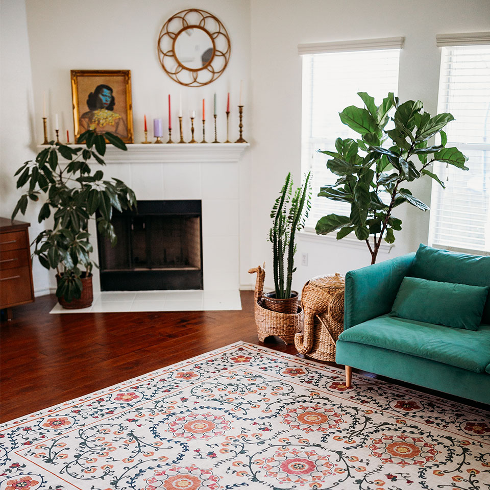 energizing orange floral rug in living room with green sofa