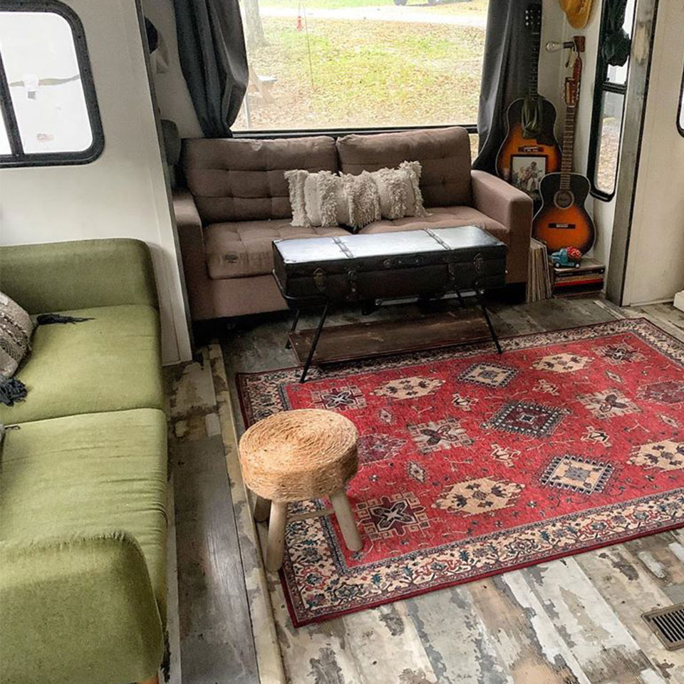 red persian rug in rv with green sofa