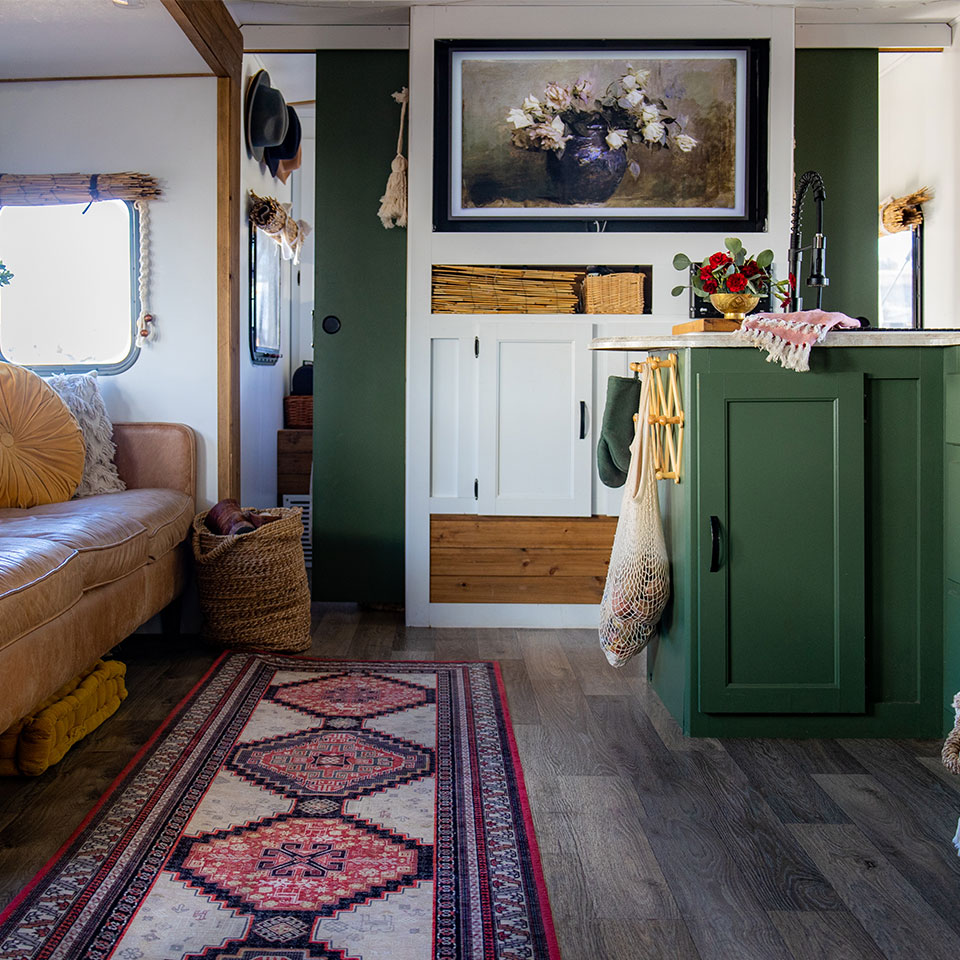 red persian runner rug in rv with green cabinets